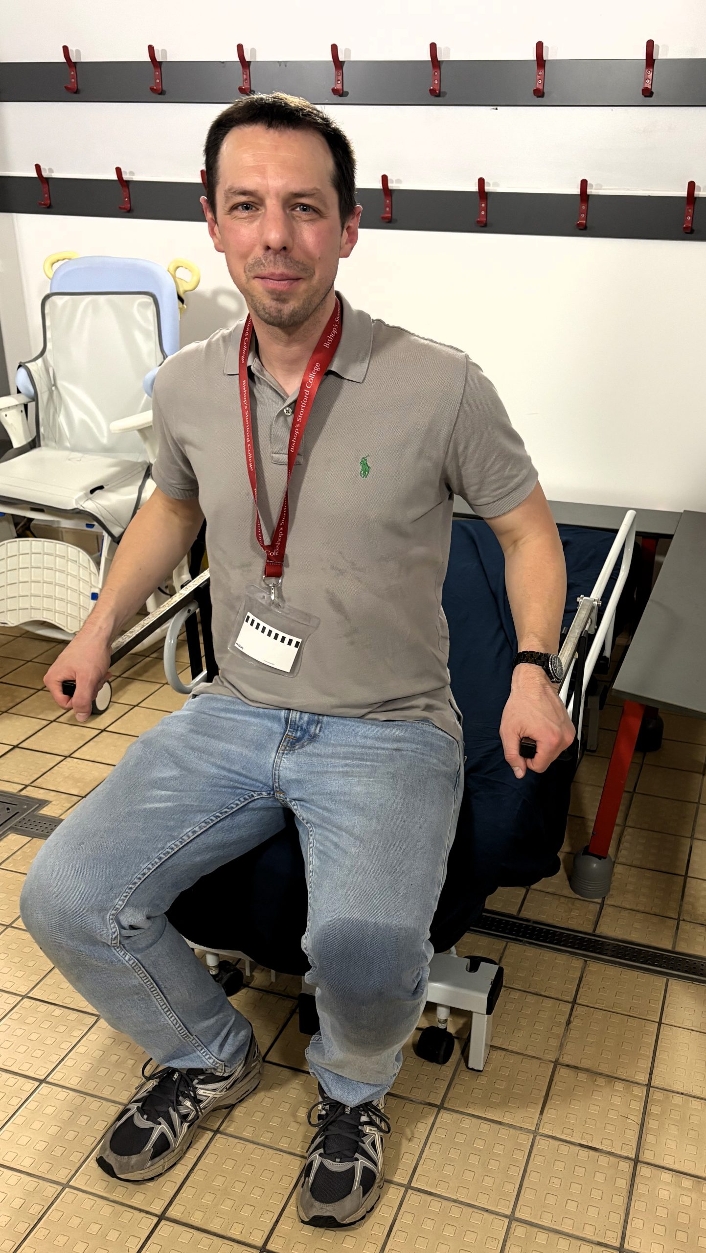 REMAP engineer sitting on a changing bed demonstrating how it is used
